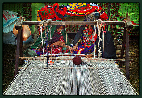 Women weaving cloth on a handloom